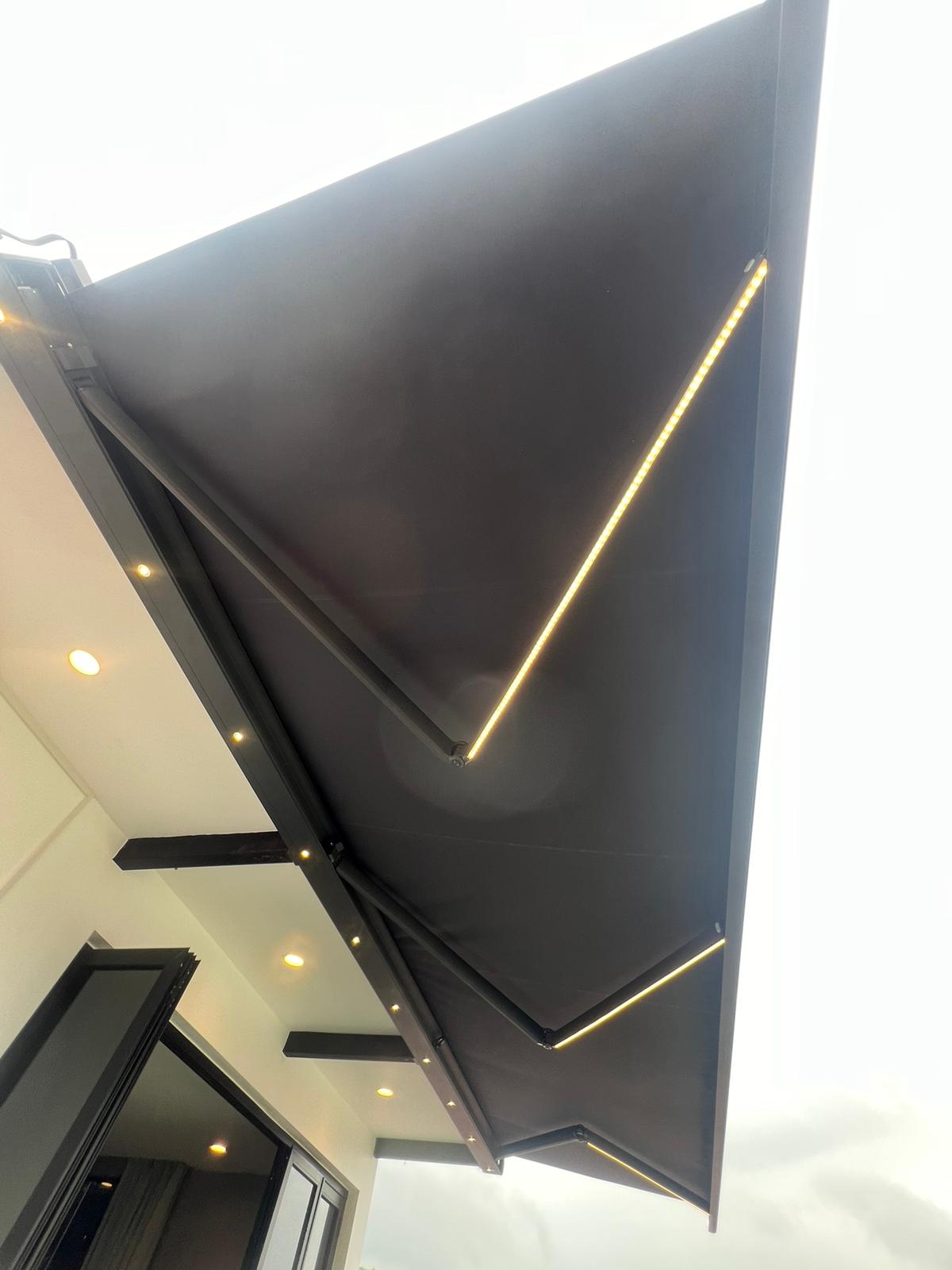 Retractable awning viewed from below with integrated lighting