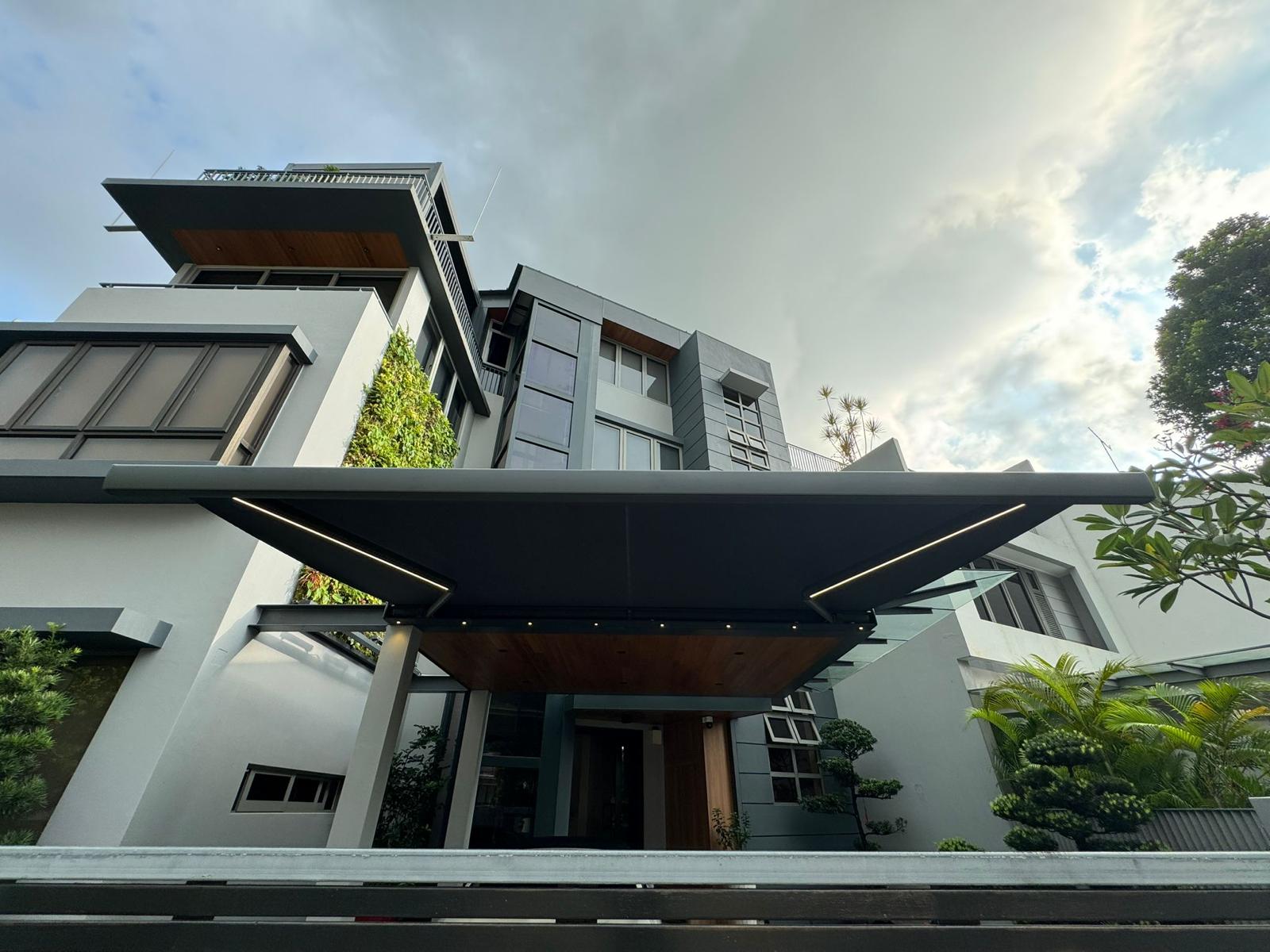 Motorised awning extending from a landed home over an outdoor area
