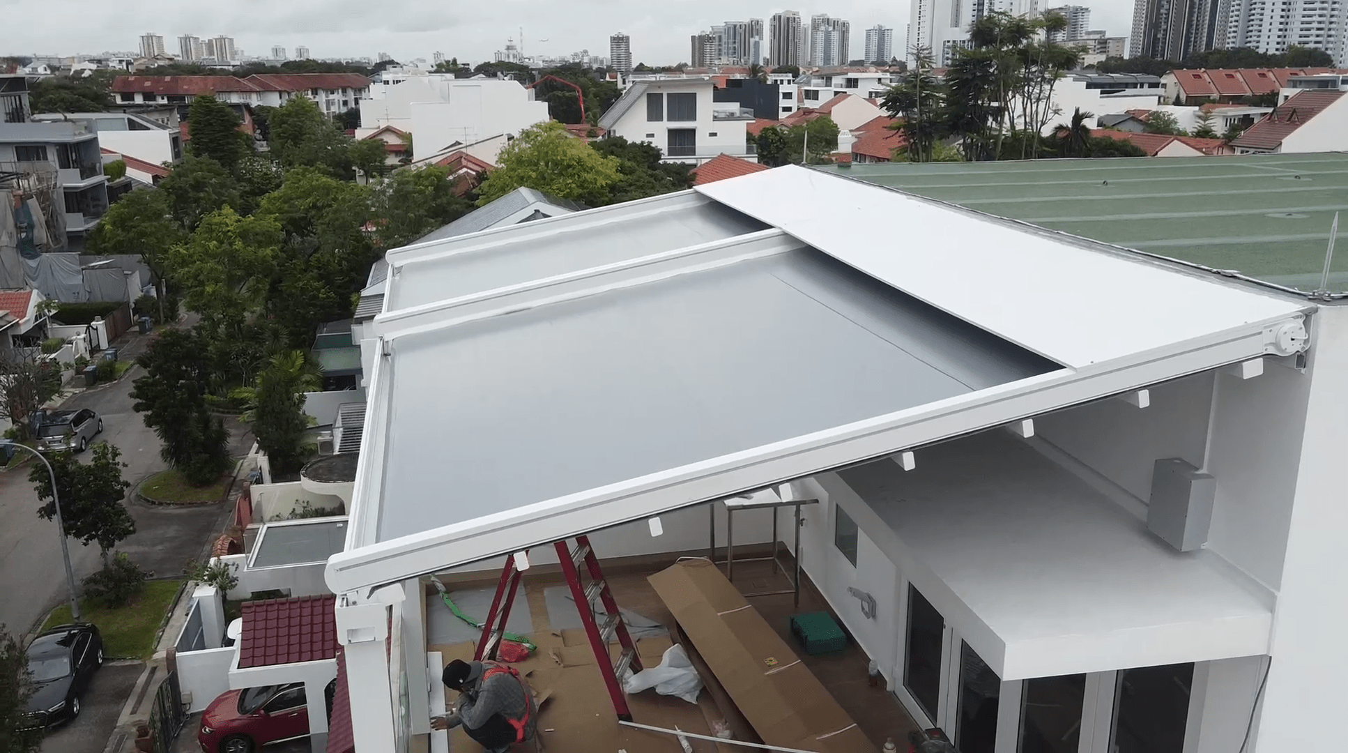 Fixed pergola roof viewed from above a residential car porch