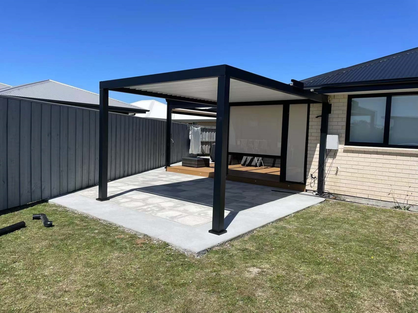 Freestanding aluminium louvered pergola over a garden patio