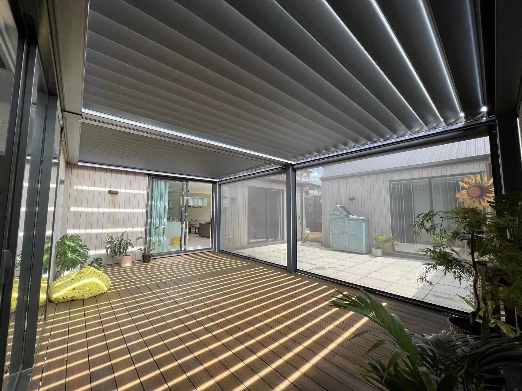 Louvered pergola with side screens creating an enclosed outdoor room