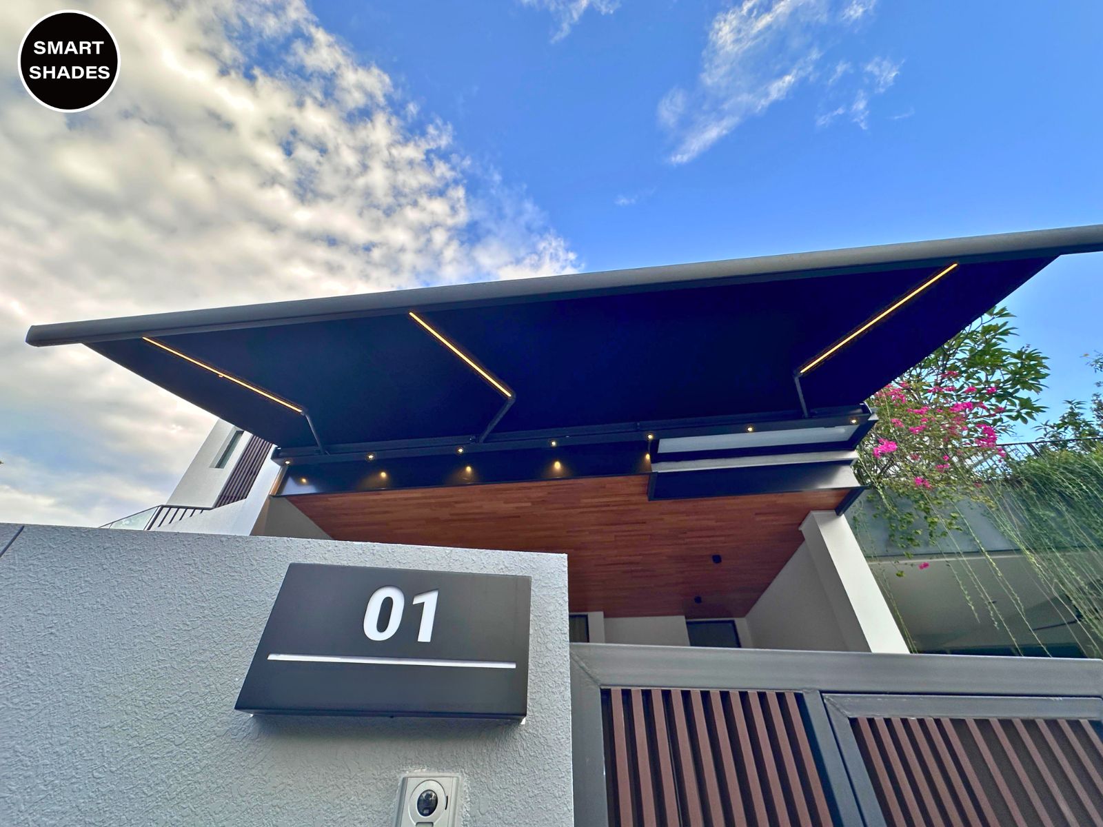 Wide retractable awning shading a Singapore driveway and car porch