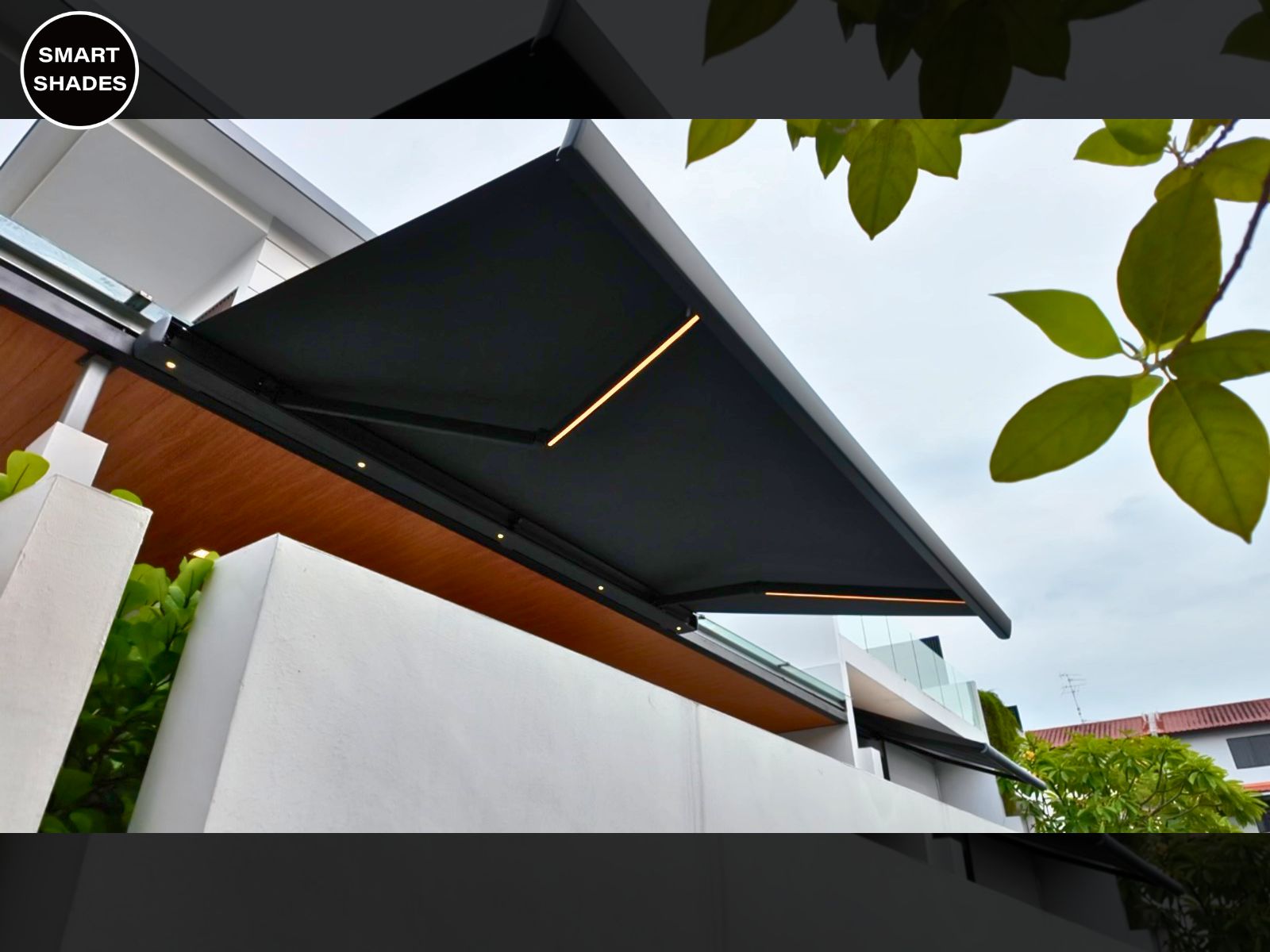 Smart retractable awning projecting shade beside a landed home