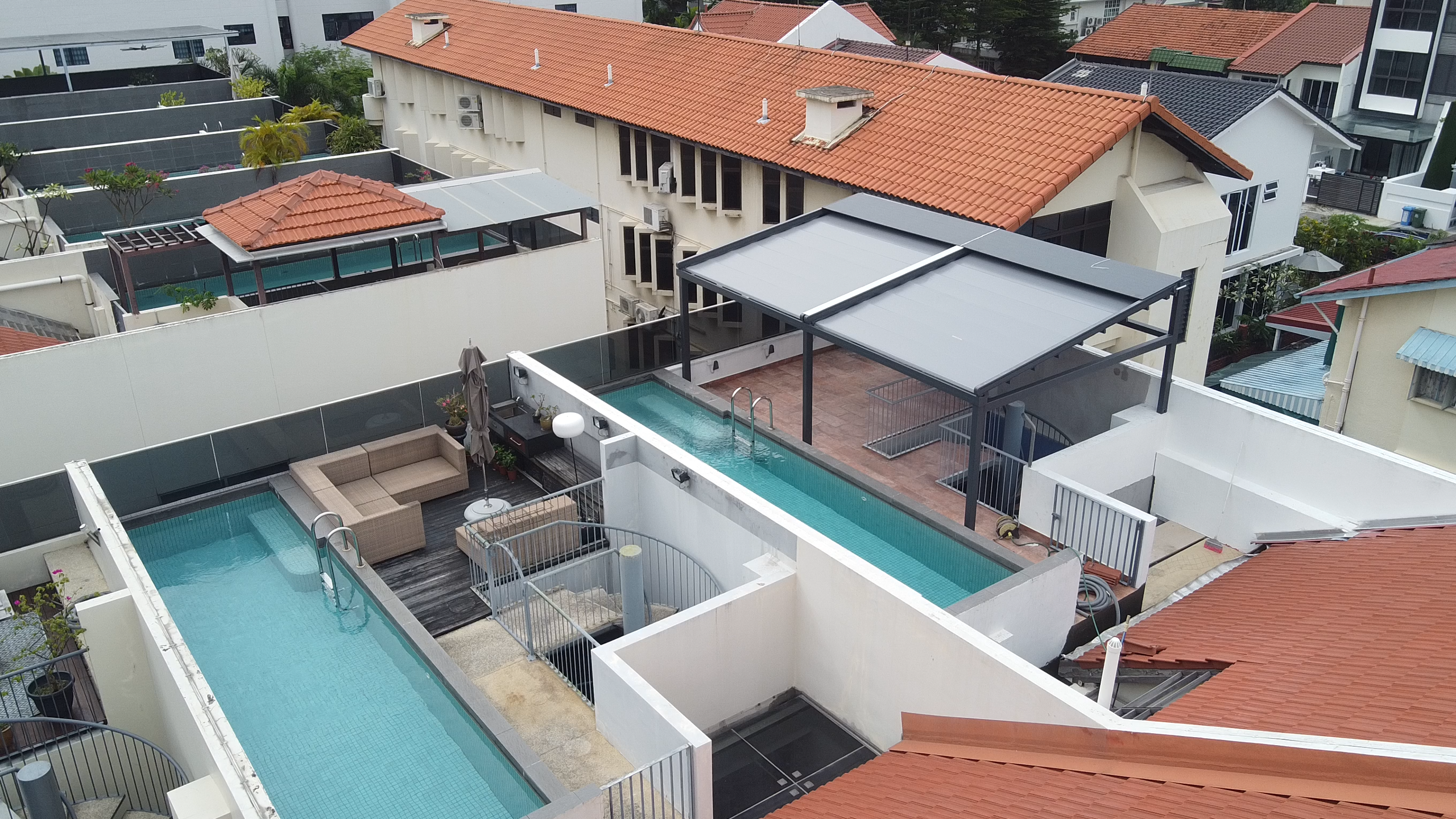 Rooftop pergola Singapore beside a swimming pool with open urban views