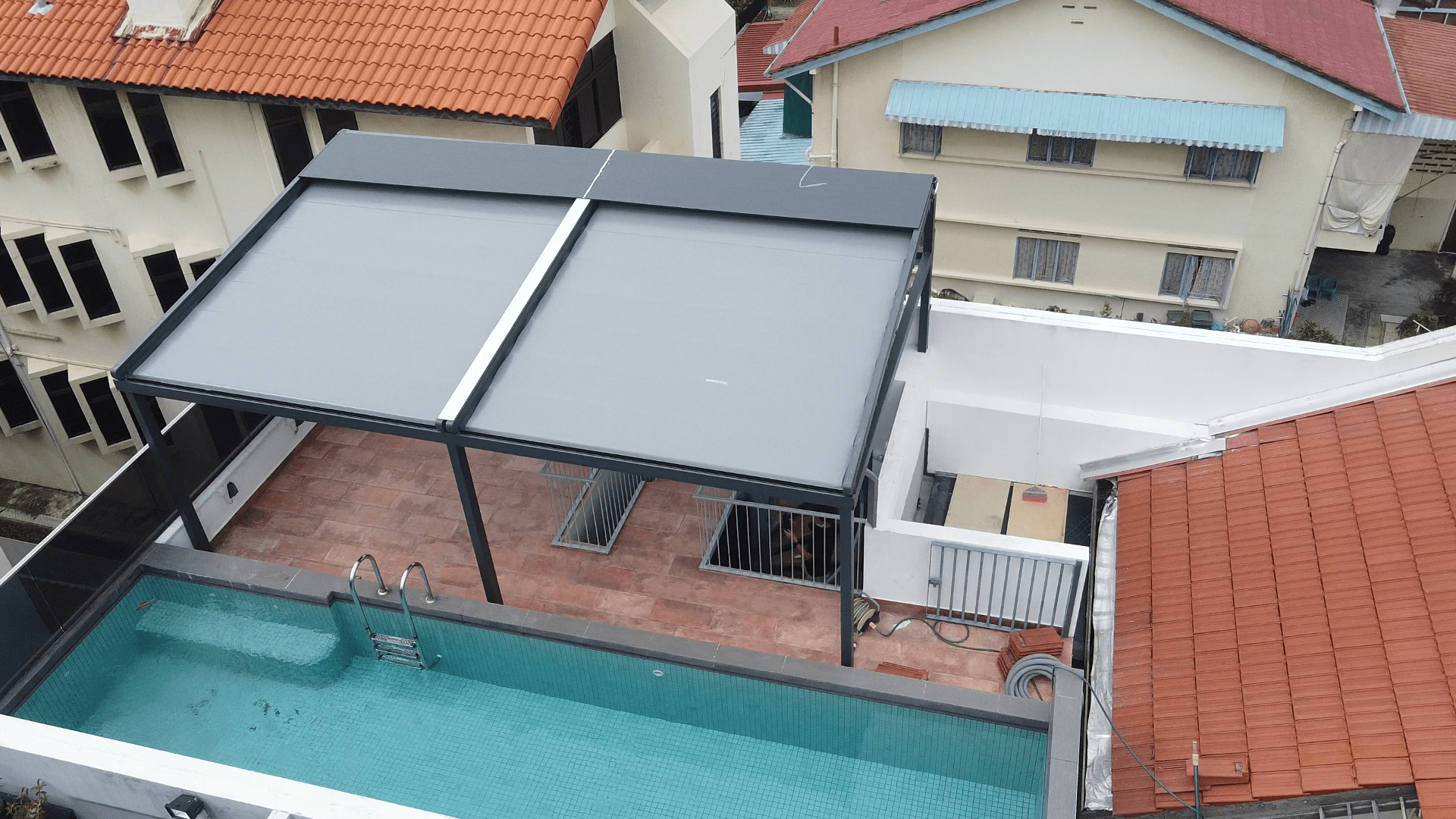 Large pergola installation providing shade beside a Singapore home