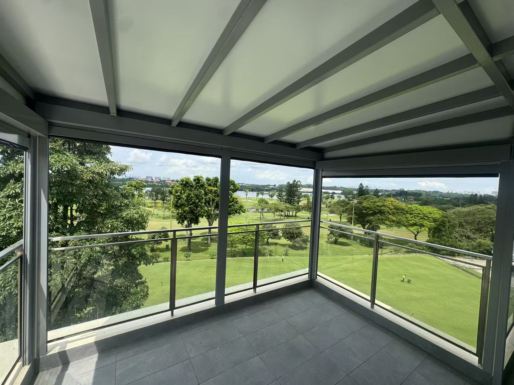 Balcony roof shelter with transparent panels and open green views