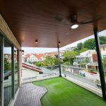 Timber-look ceiling above a covered balcony — aluminium ceiling panel