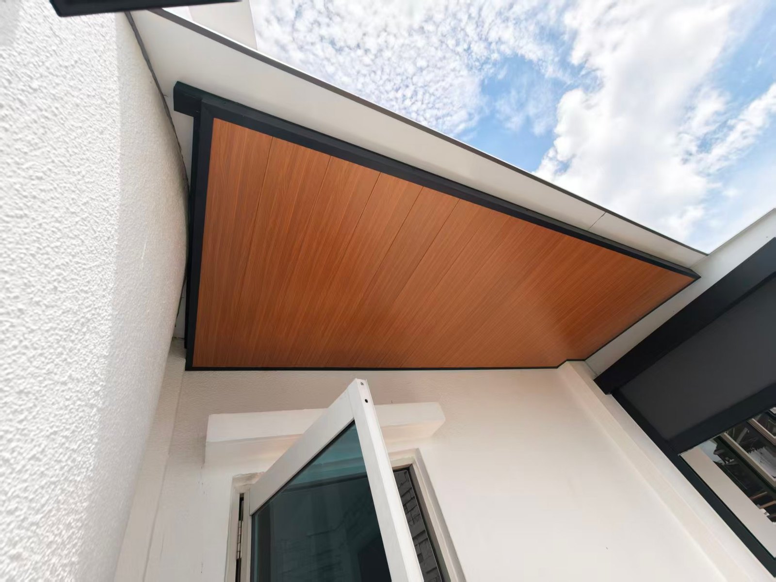 Timber-look ceiling finish within a dark perimeter frame