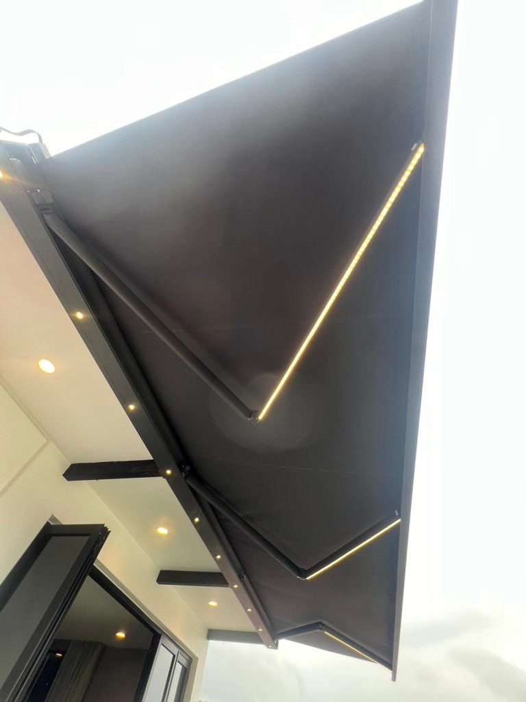 Underside of a retractable awning with articulated arms — retractable awning