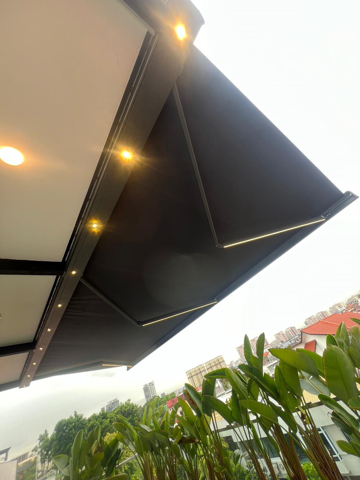 Awning edge and supporting arm beside a house