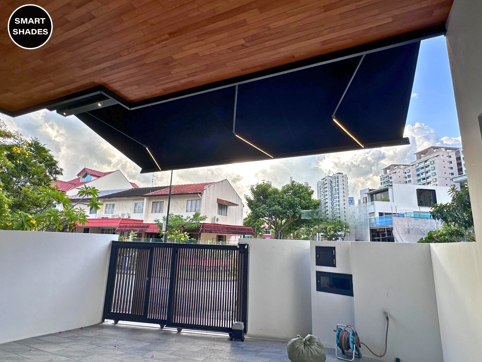 Dark awning extended beyond a timber-look porch ceiling