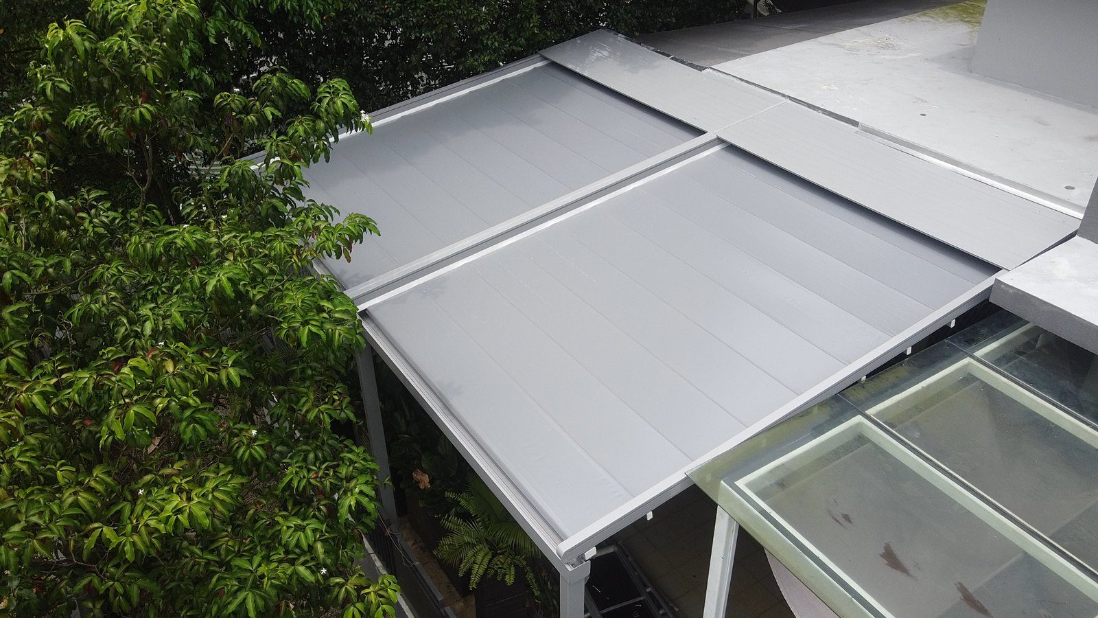 Roof structure viewed from above beside an existing building