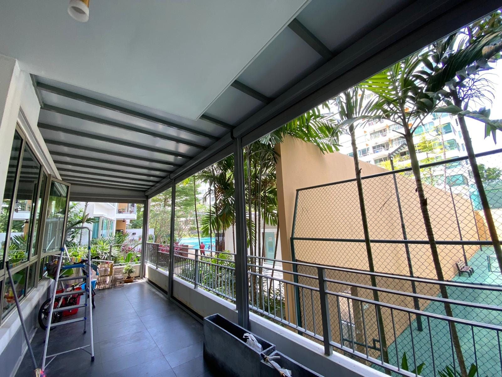 Covered passage showing the frame beside garden planting